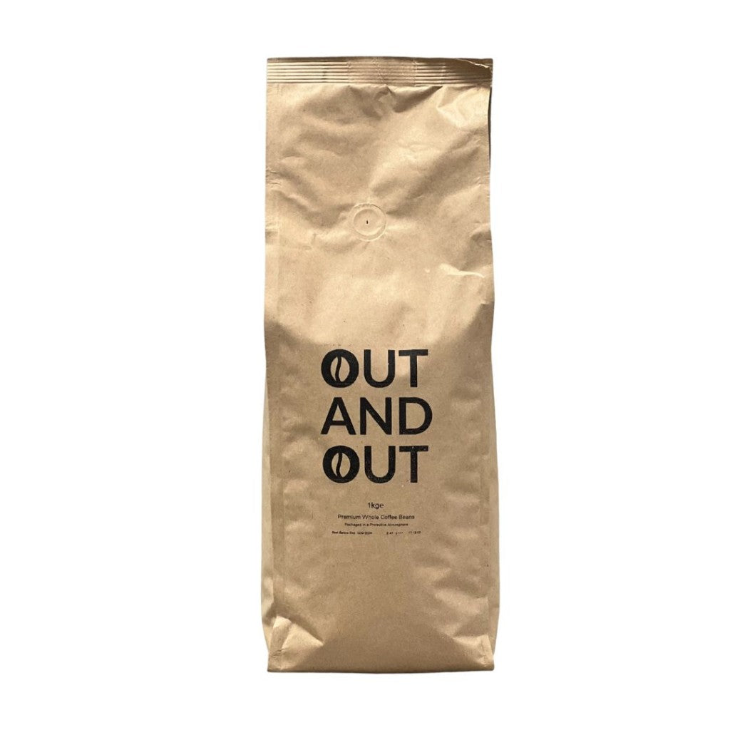 Close-up of OUT AND OUT Coffee 1kg bag showing premium blend details and logo.